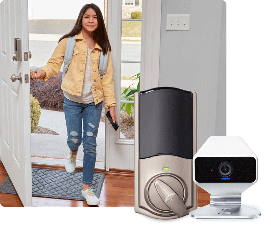 Young woman walking into house next to smart lock and camera